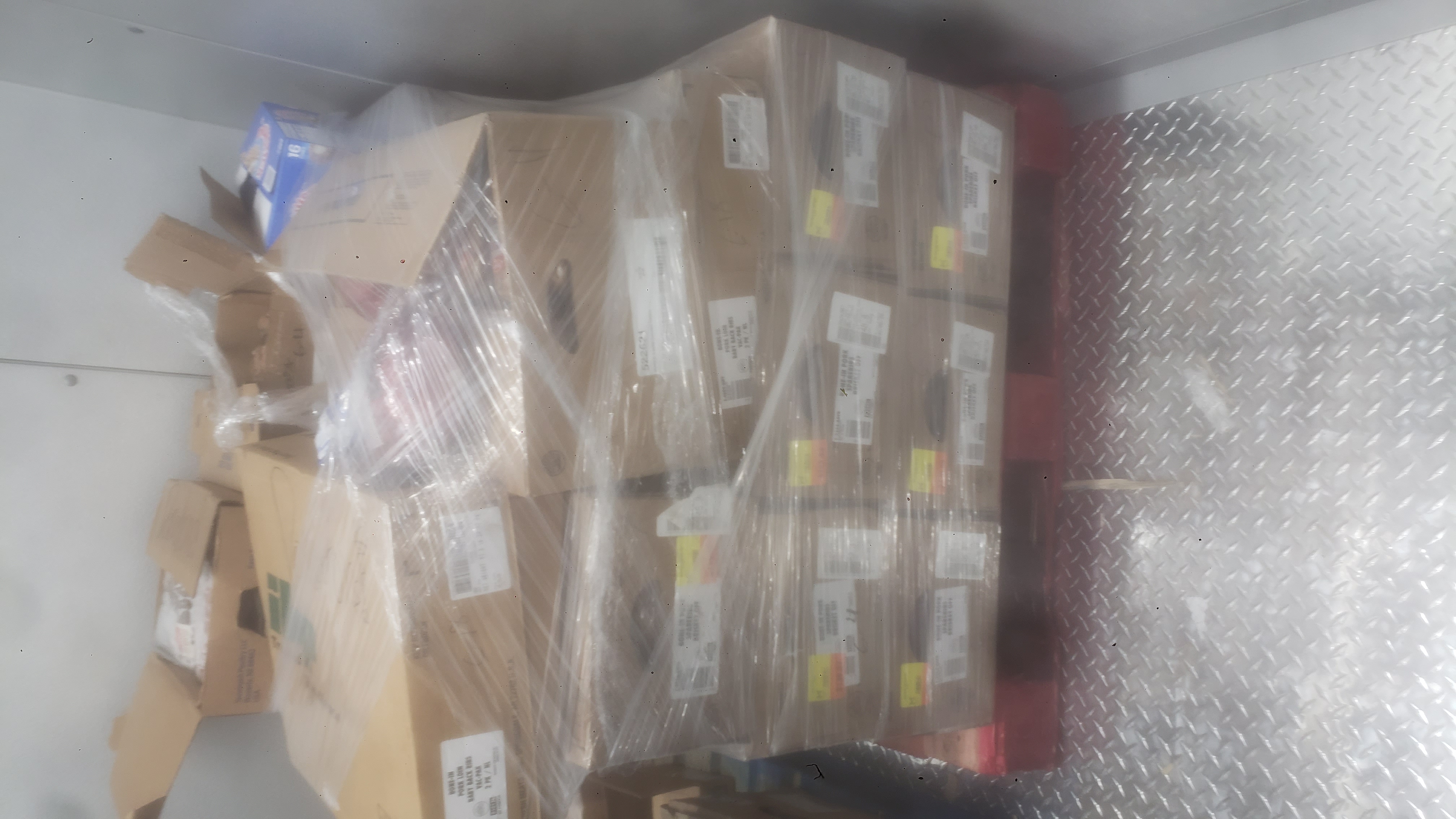 Cardboard boxes wrapped in plastic on a pallet.